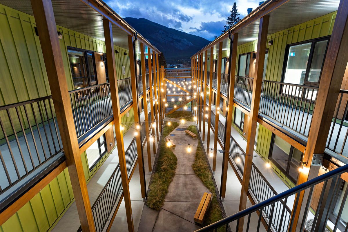 The Aster — Courtyard at dusk · Photograph